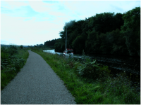 Sailing boat motoring 'down' the Crinan Canal towards Lochgilphead.png